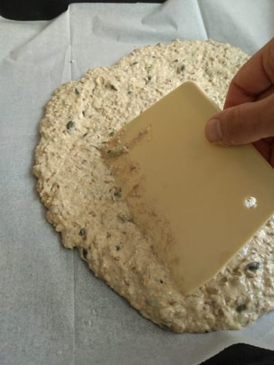 Spelt cracker crisps, does that sounds like something only a professional bakery can make or the kind of stuff we would buy in the wholefood store. well, its not and i tell you this, they are so easy to make you would ask yourself why did i pay so much for it. I guess its because Spelt Cracker Crisps are considered as health food and when labled as such, the price immediately jumps up. Let me spelt it to you I use a mix of spelt and whole wheat flour, both of them high in fibers and protein and have good glutamic values (easy to digest). the behaviour of spelt flour is very much similar to white flour, it becomes crispy when baked, it does not absorb high amount of water (like rye flour for example), and most important, it taste amazing. The spelt considered as a non wheat grain that has the most similar behavoouse in baking to white flour without compromising the texture or taste of the pastry. Spelt genetics was not tempered over the years as wheat, today we probably eat the same spelt as was eaten 5000 years ago. OK, give me some Spelt cracker crisps there are a few guidelines to these wonderful crackers that some will be learnt in time and some mistakes can be avoided. the texture of the mixture should be guyee and a bit runny but still firm enough to rub on the parchment paper, if needed add or reduce water and whatever you do add the water in small batches to control the texture. try to make the layer of the cracker as thin as possible, this will ensure a crunchy texture that we are after. you can use whatever grains comes to your mind however keep the Nigella seeds and sesame, they are a big flavor enhancer. Baking is everything baking is on low heat of 160°c/ 320°F, we want to dry out all the liquids in the dough to end up with a crunchy texture crisp crackers. after about 15 minutes while crackers are still a bit wet we cut them half way, we dont cut with the knife all the way thru (I like to use the Pizza roll to do this). Spelt cracker crisps after we mark the Spelt cracker crisps we need to rotate the baking pan for an even baking, and you can rotate it one more time if you see they are getting burnt on one side (remember they are very thin). Spelt cracker crisps These Vegan healthy crackers are amazing eating on their own or paired with your favorite dip or perhaps come with a cheese board. in any case you